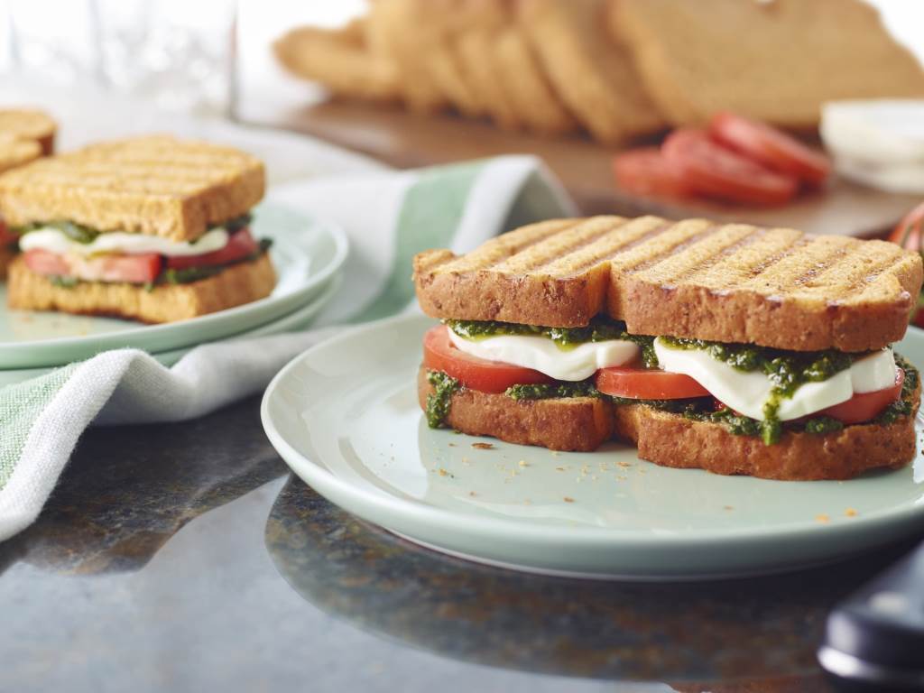 Caprese Panini cut in half on a plate