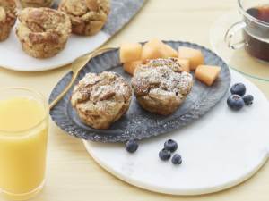 French Toast Cups on a plate with fresh blueberrries and melon